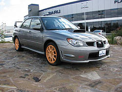 Photoshop request! Can someone change the wheel color of this STi?-orange.jpg